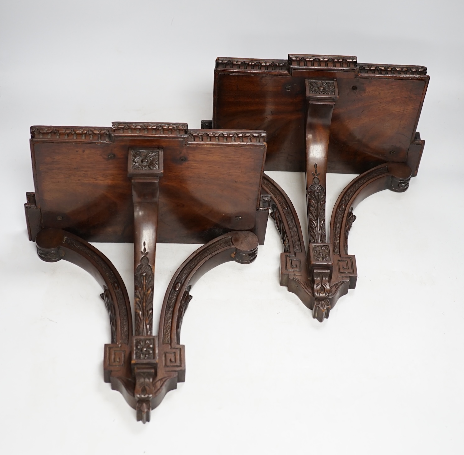 A pair of Edwardian Sheraton Revival mahogany wall brackets, 28cm high. Condition - fair to good